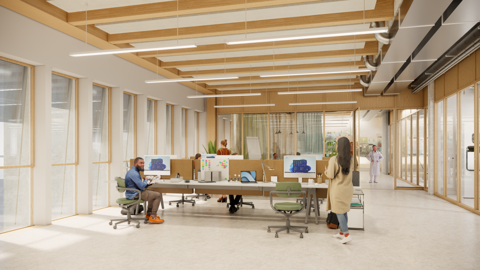 BUREAUX Open office space with employees working at desks in a modern interior