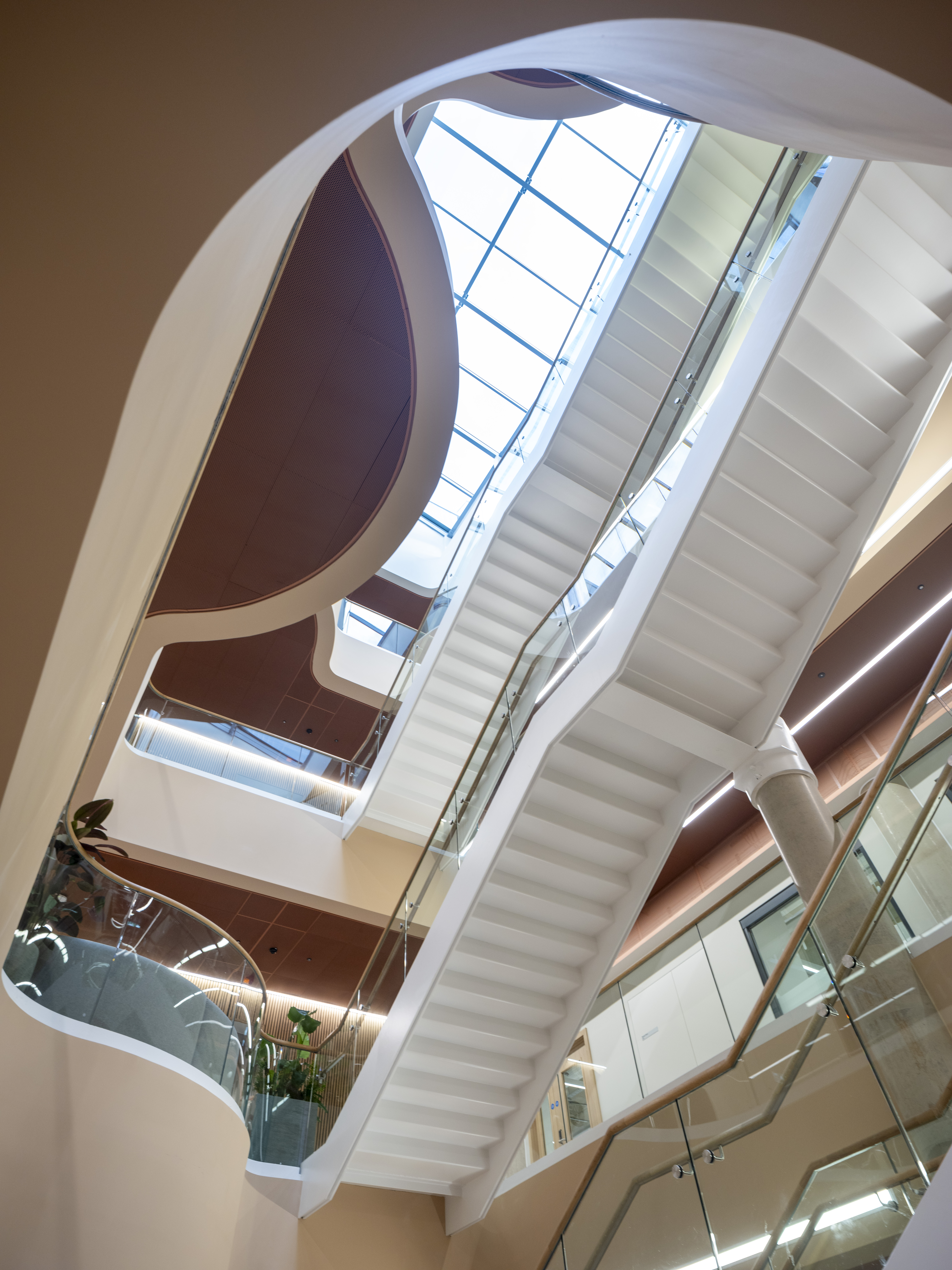 Exterior of a modern building with contemporary architecture, stairs and surrounding greenery
