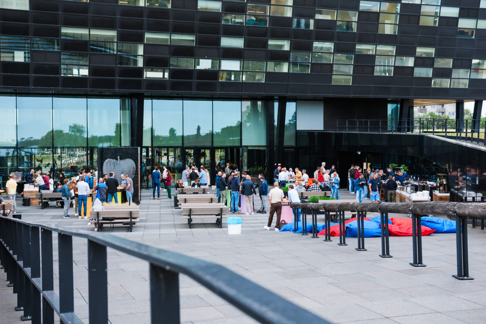 Community event at the Kadans Science Partner campus in Nijmegen, with researchers and professionals gathering outside the black tower.