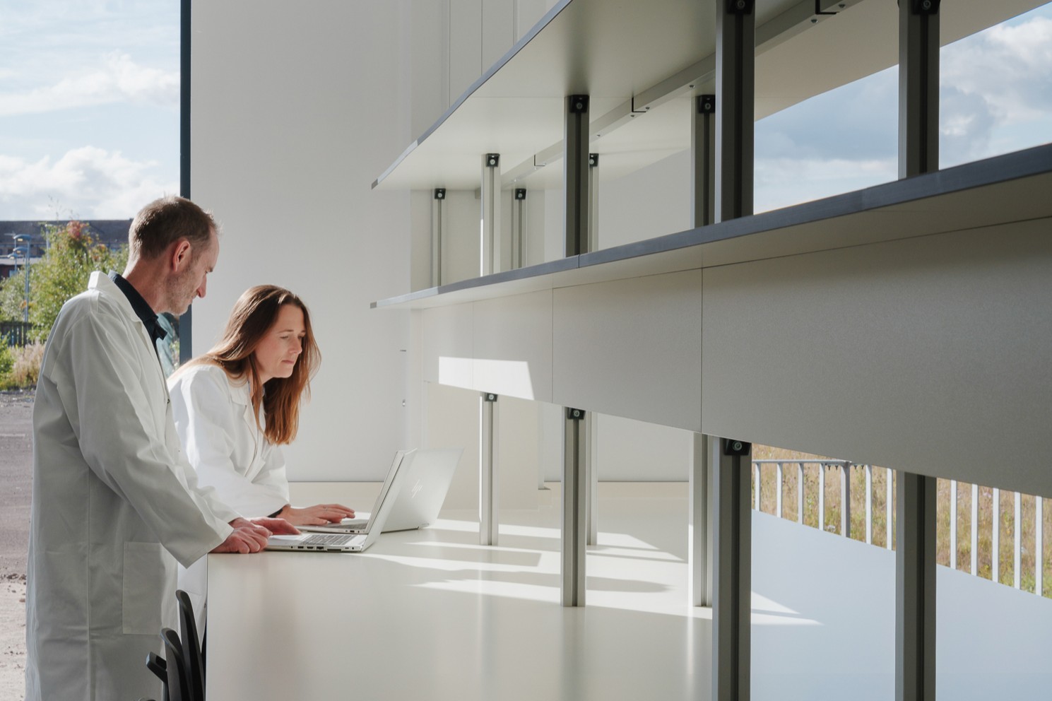 A man and a woman collaborating in a lab environment